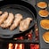 Steaks and pancakes cook over an open fire